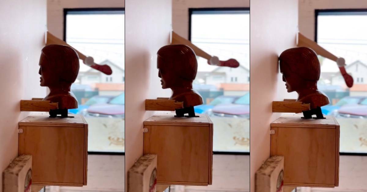 Artist creates “most relatable sculpture ever” of a human head that constantly bangs its head against the wall