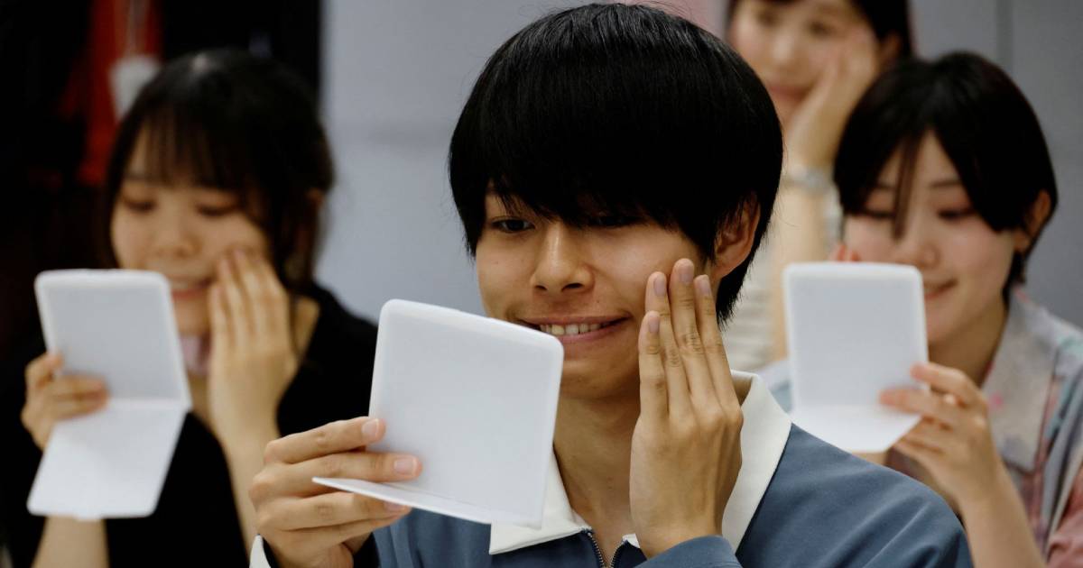 People in Japan who got used to face masks during COVID are attending smiling lessons