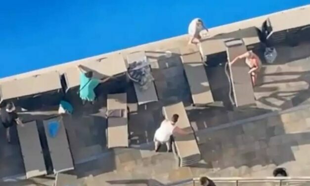 Holidaymakers queue for two hours at crack of dawn to secure sunbeds in bizarre scenes