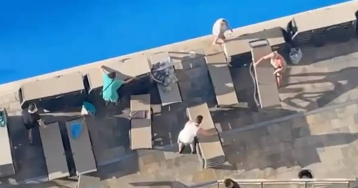 Holidaymakers queue for two hours at crack of dawn to secure sunbeds in bizarre scenes