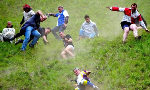 Cheese-loving daredevils hurl themselves down Cooper’s Hill in Gloucestershire for famous race